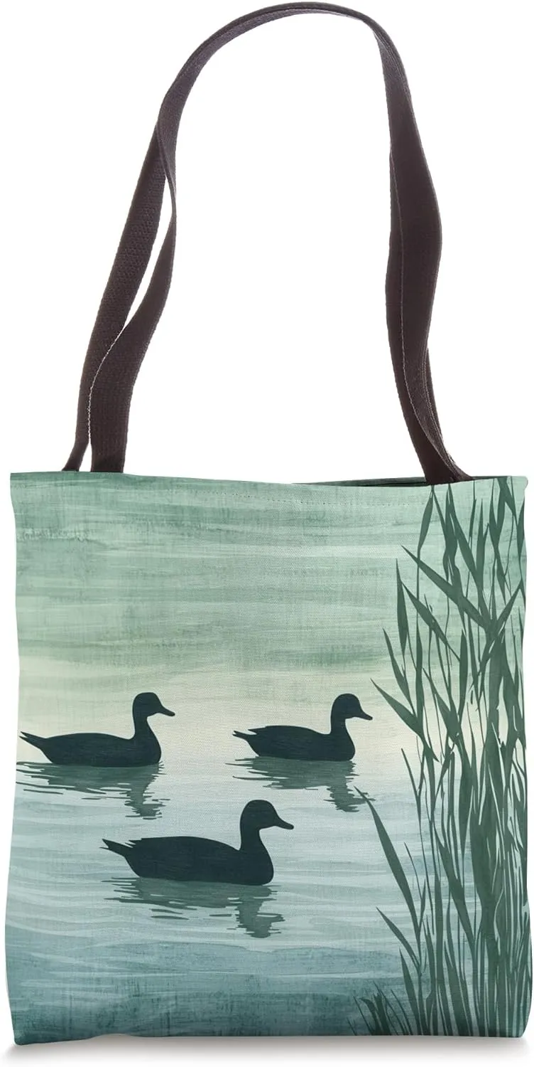 Silhouette Ducks on a Serene Pond, Nature's Tranquil Beauty Tote Bag